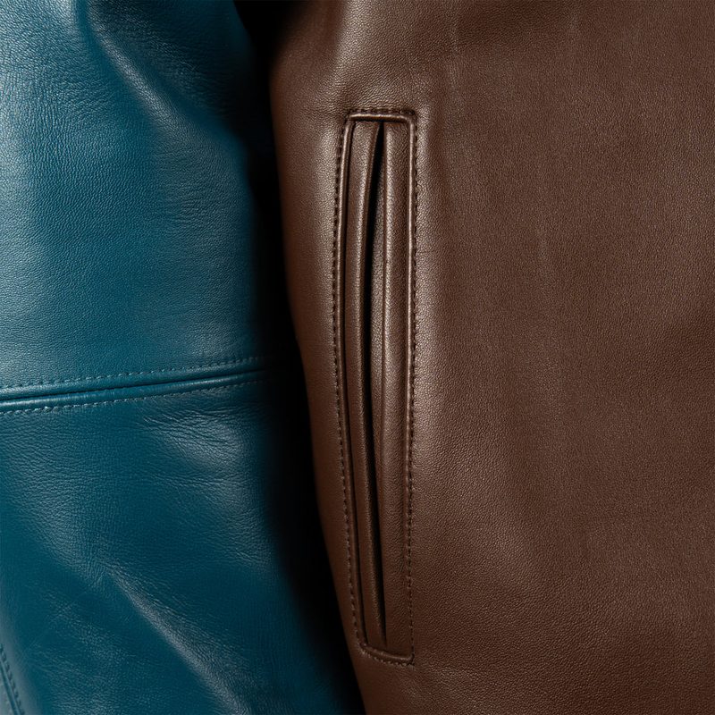 100% Genuine leather - Contrast color saddle seam leather sleeves  - Self leather with direct embroidered wearers left chest artwork  - Marc Buchanan "MB" leather applique branding with rhinestone branding on the wearers left sleeve  - Oversized 2 ply "Pelle Pelle" leather applique artwork with multiple rhinestone placements  - Satin lining with outlined direct embroidered "Pelle Pelle"  - Interior pockets at the inside lining  - Leather collar - Heavy 2x2 rib cuff and hem  - Pelle Pelle custom branded front zipper pull  (5)