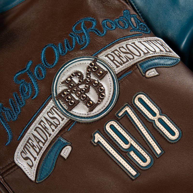 100% Genuine leather - Contrast color saddle seam leather sleeves  - Self leather with direct embroidered wearers left chest artwork  - Marc Buchanan "MB" leather applique branding with rhinestone branding on the wearers left sleeve  - Oversized 2 ply "Pelle Pelle" leather applique artwork with multiple rhinestone placements  - Satin lining with outlined direct embroidered "Pelle Pelle"  - Interior pockets at the inside lining  - Leather collar - Heavy 2x2 rib cuff and hem  - Pelle Pelle custom branded front zipper pull  (4)